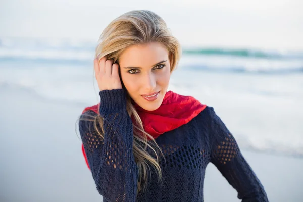 Cheerful gorgeous blonde running her hand through her hair — Stock Photo, Image