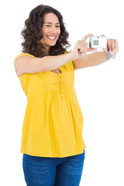 Curly haired brunette taking picture of herself — Stock Photo, Image