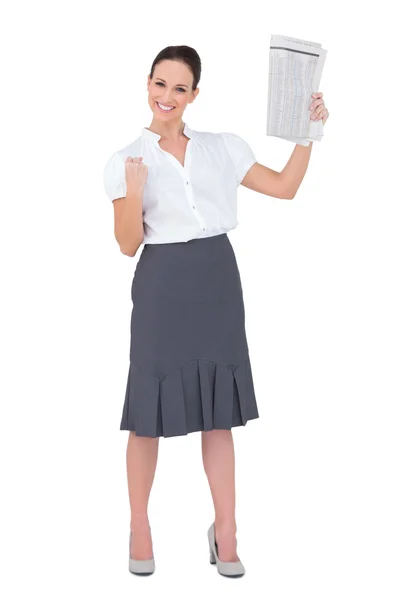 Victorious stylish businesswoman holding newspaper — Stock Photo, Image