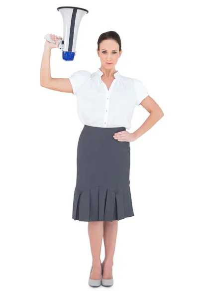 Serious businesswoman holding megaphone — Stock Photo, Image