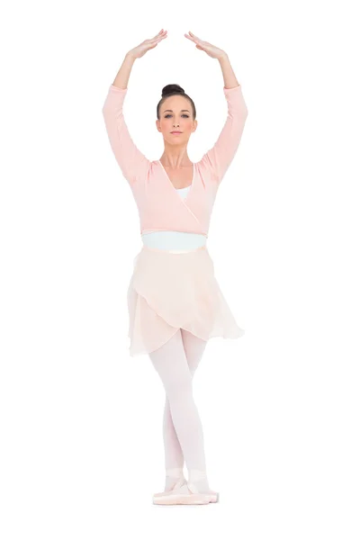 Concentrated gorgeous ballerina standing in a pose — Stock Photo, Image