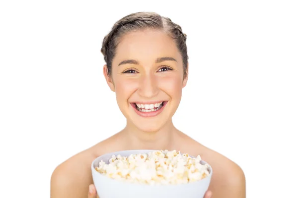 Cheerful natural model holding popcorn — Stock Photo, Image