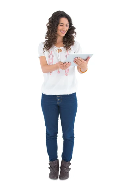 Attractive casual brunette using her tablet pc — Stock Photo, Image