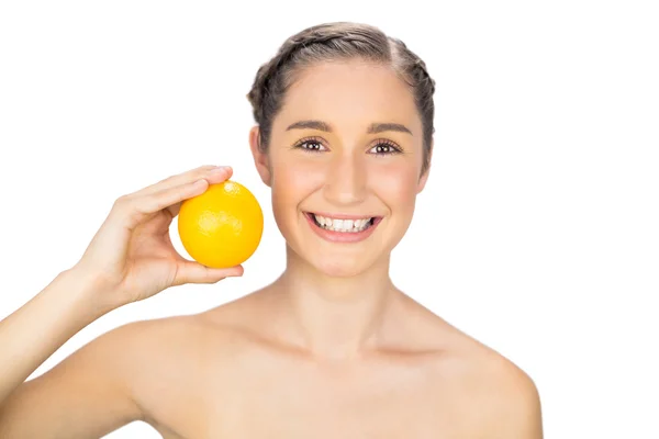 Smiling natural model holding orange — Stok fotoğraf