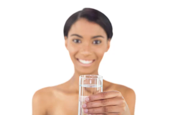 Cheerful attractive model holding glass of water — Stock Photo, Image