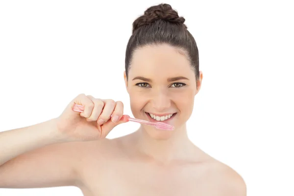 Cheerful pretty model brushing her teeth — Stock Photo, Image