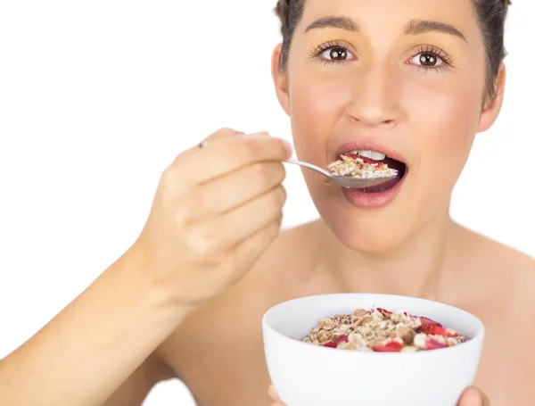 Smiling healthy model eating cereals — Stock Photo, Image