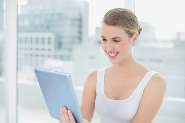 Cheerful cute blonde holding digital tablet — Stock Photo, Image