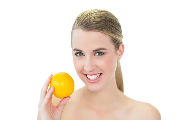 Cheerful attractive blonde holding orange — Stock Photo, Image