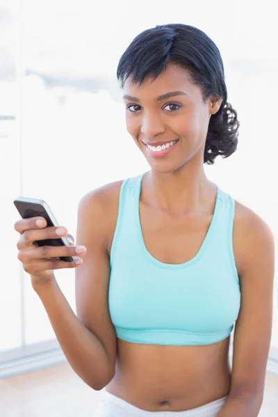 Content fit woman texting with her mobile phone — Stock Photo, Image