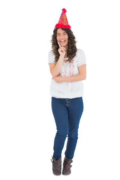 Smiling casual brunette with party hat posing — Stock Photo, Image