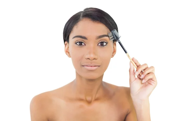 Gorgeous natural model using eyebrow brush — Stock Photo, Image