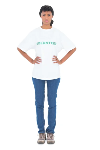 Serious black haired volunteer posing with hands on the hips — Stock Photo, Image