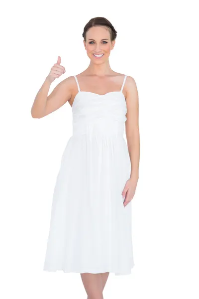 Smiling young model showing thumbs up — Stock Photo, Image