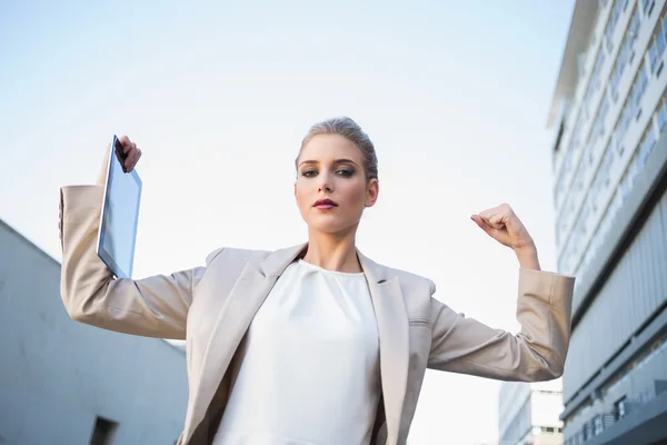 Low angle view of serious classy businesswoman making victory gesture — Stock Photo, Image
