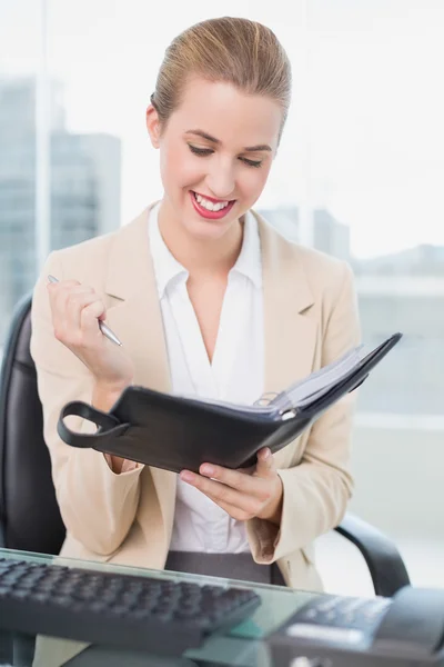 Smiling attractive businesswoman holding her agenda — Stock Photo, Image