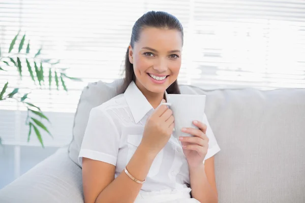 Smiling gorgeous woman holding hot coffee — Stock Photo, Image