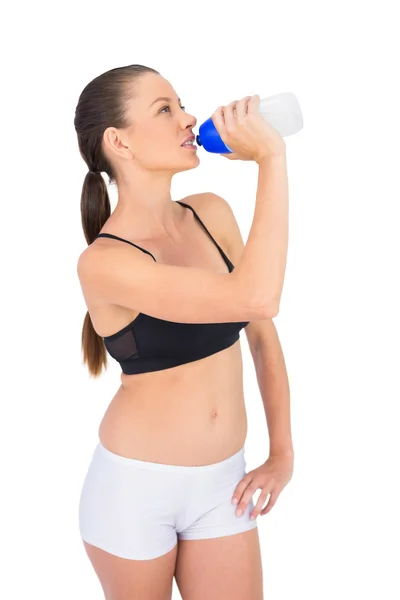 Toned woman in sportswear drinking water — Stock Photo, Image