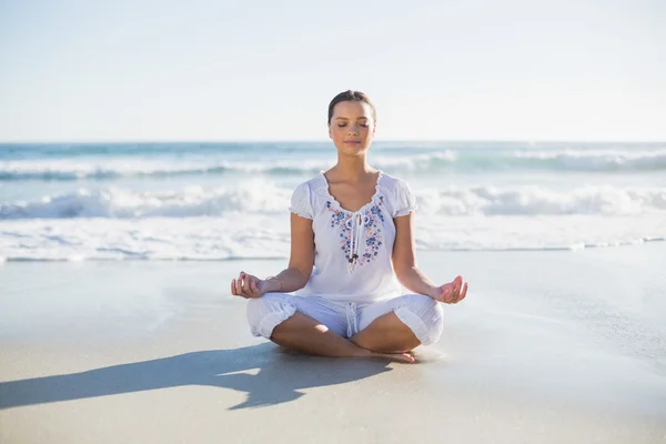Peaceful pretty woman in lotus position on the beach — Stock Photo, Image