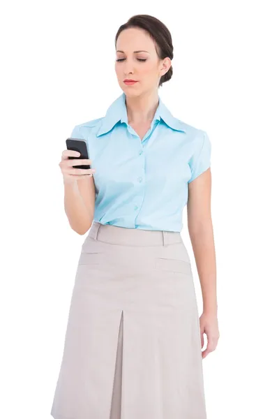 Serious classy young businesswoman sending text message — Stock Photo, Image