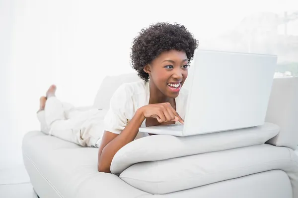 Smiling pretty brunette using her laptop — Stock Photo, Image