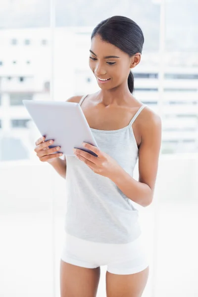 Peaceful sporty model holding tablet computer — Stock Photo, Image