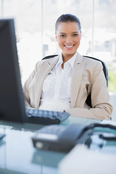 Smiling businesswoman sitting on swivel chair — Stock Photo, Image