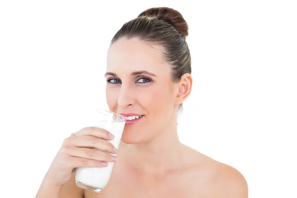 Happy woman drinking milk and looking at camera Stock Photo