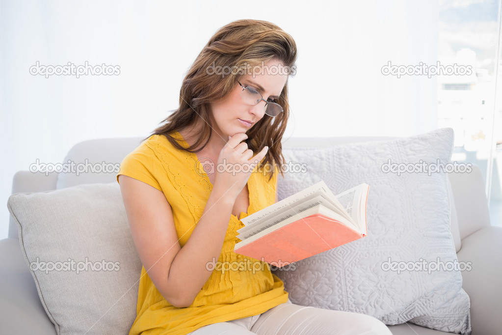 Thoughtful woman reading book