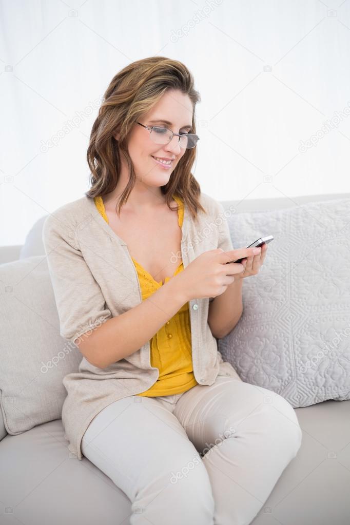 Smiling casual woman using her smartphone