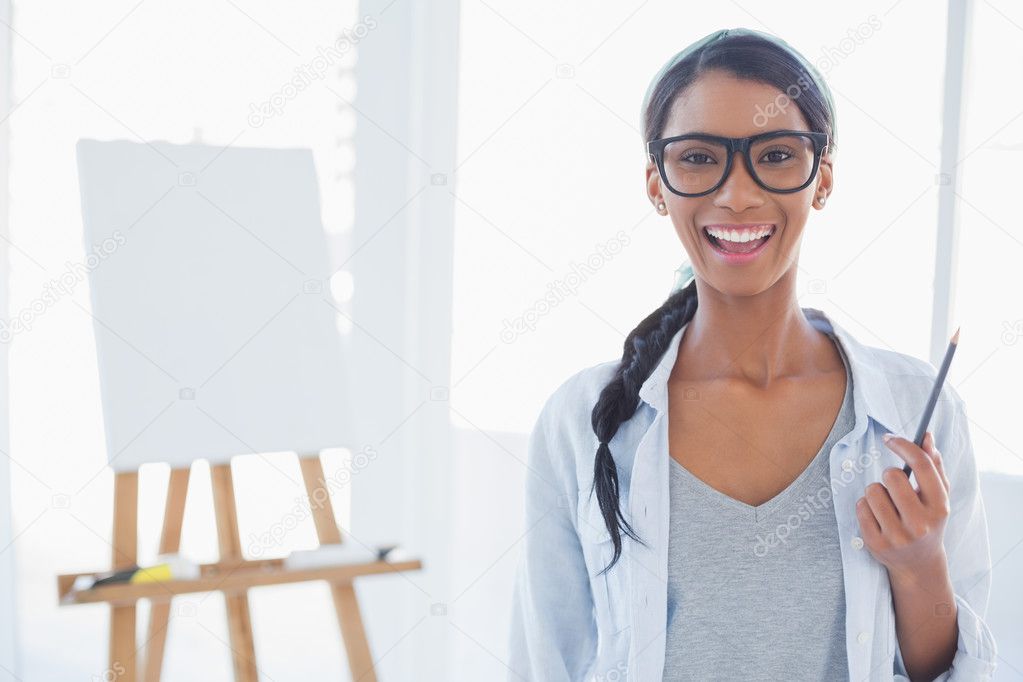 Cheerful attractive artist holding drawing pencil
