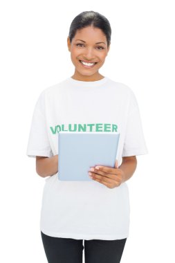 Tablet holding gönüllü tişörtü giyen mutlu modeli