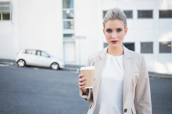 Serious stylish businesswoman holding coffee — Stock Photo, Image