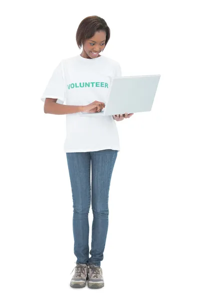 Cheerful volunteer woman using laptop — Stock Photo, Image