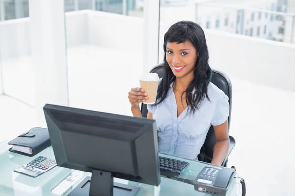 Charming businesswoman holding a cup of coffee — Stock Photo, Image