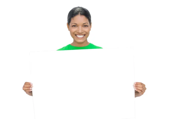 Smiling model holding white sign — Stock Photo, Image