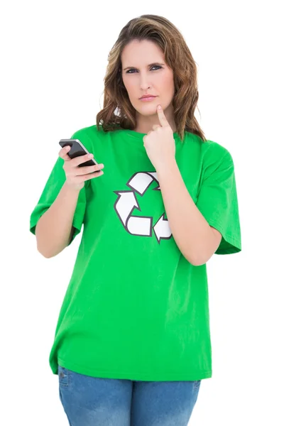 Thoughtful environmental activist holding phone looking at camera — Stock Photo, Image