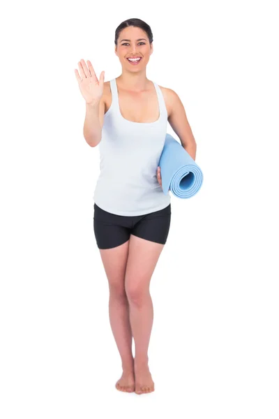 Happy slender model holding her rolled up mat — Stock Photo, Image