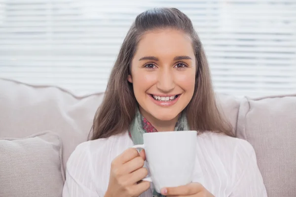 Smiling pretty model holding cup of coffee — Stock Photo, Image