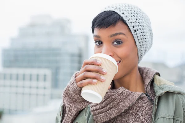 Happy young model in winter clothes enjoying coffee — Stock Photo, Image