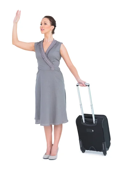 Gorgeous woman carrying her suitcase calling taxi — Stock Photo, Image
