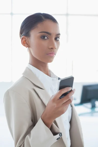 Stern elegant businesswoman text messaging — Stock Photo, Image