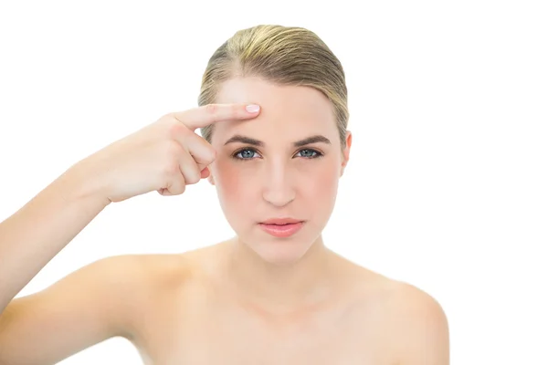 Pretty blonde pointing at wrinkle on her forehead — Stock Photo, Image