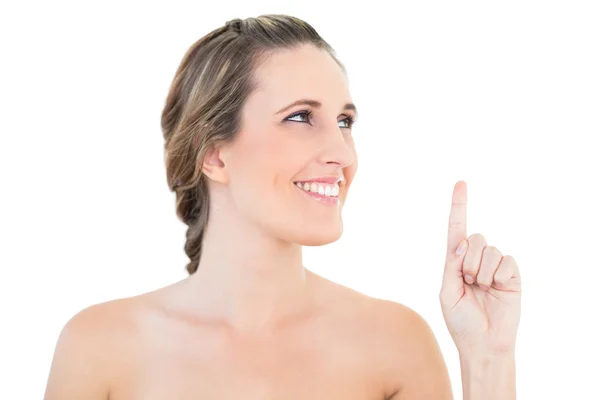 Cheerful woman pointing and looking up — Stock Photo, Image