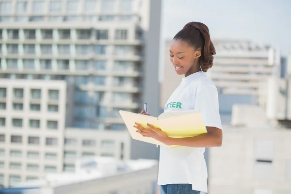 Smiling altruist woman holding notebook — Stock Photo, Image