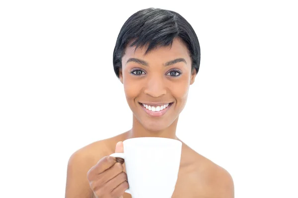 Content black haired woman holding a cup of coffee — Stock Photo, Image