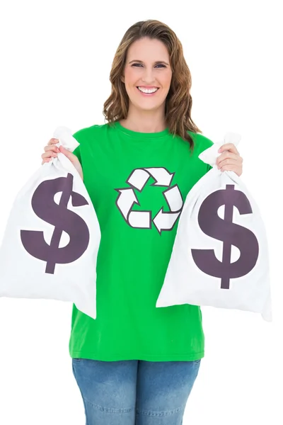 Smiling environmental activist holding money bags — Stock Photo, Image