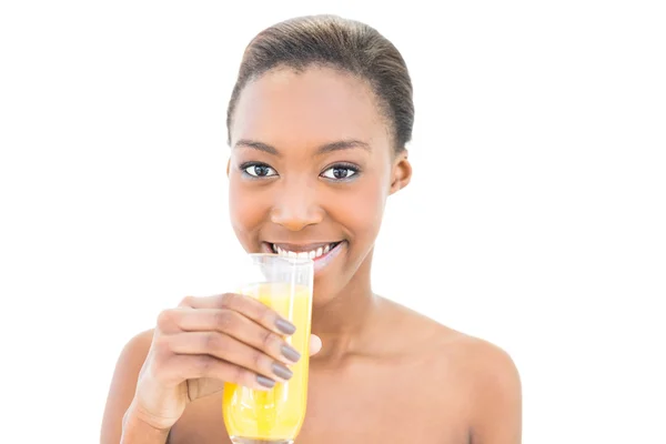 Cheerful natural beauty drinking orange juice — Stock Photo, Image