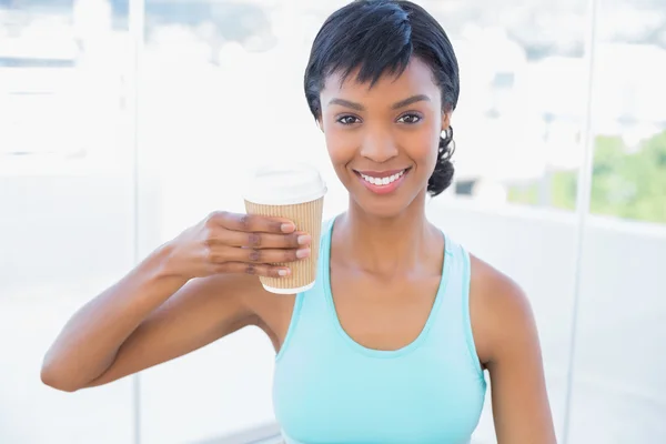 Pleased black haired woman holding a beverage — Stock Photo, Image