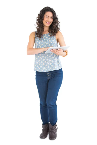 Cheerful attractive brunette using her tablet — Stock Photo, Image